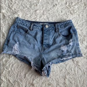 Distressed cheeky jean shorts